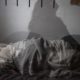 person lying awake in bed during sleep disruption in early methamphetamine recovery
