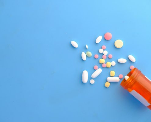 Prescription bottle with pills on a counter — residential rehab for chronic pain and opioid use disorder