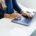 A professional working on a laptop indoors — executive residential rehab remote-work track