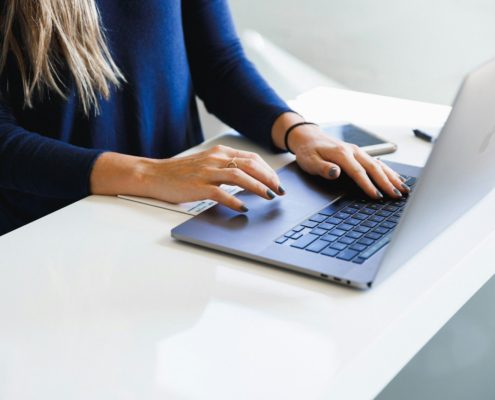 A professional working on a laptop indoors — executive residential rehab remote-work track