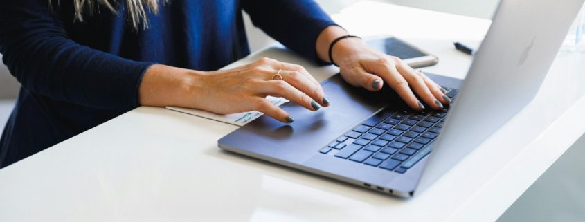 A professional working on a laptop indoors — executive residential rehab remote-work track