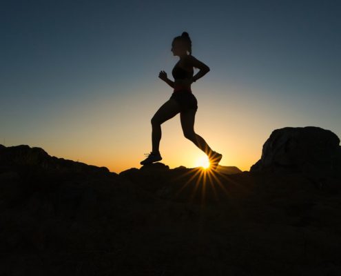 Sunlit running trail through nature, representing the role of movement and exercise in early addiction recovery