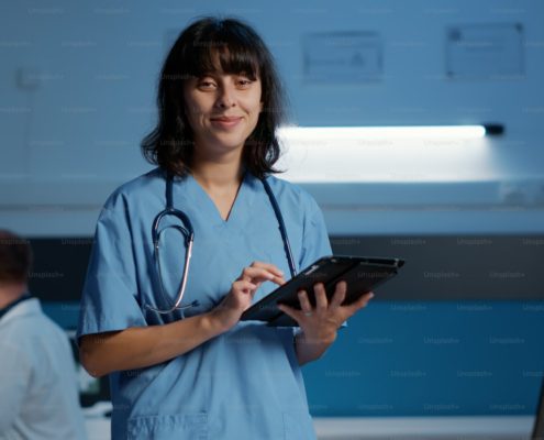 Nurse reviewing medical records at a computer during an overnight shift in a residential detox unit