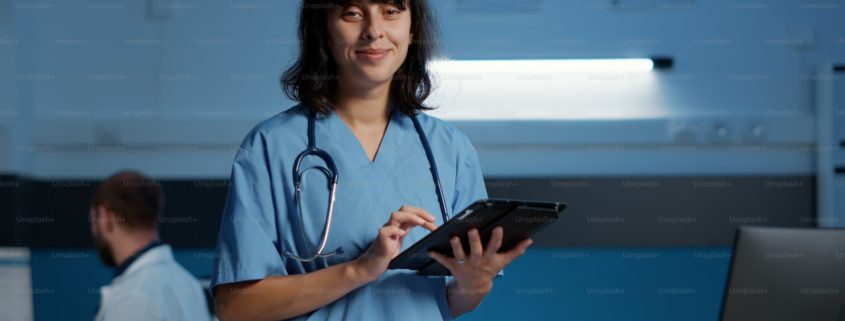 Nurse reviewing medical records at a computer during an overnight shift in a residential detox unit