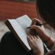 A person writing in a notebook indoors — preparing emotionally for residential addiction treatment