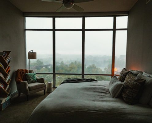 Peaceful bedroom in early morning light, representing the difficulty and importance of sleep in early addiction recovery