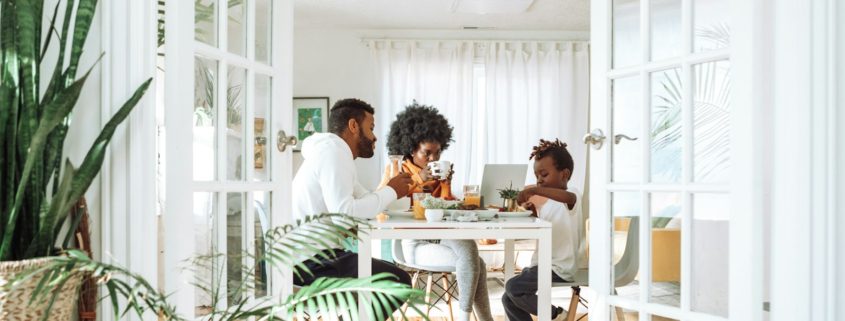People sitting at a table in a calm indoor conversation — talking to a loved one about rehab