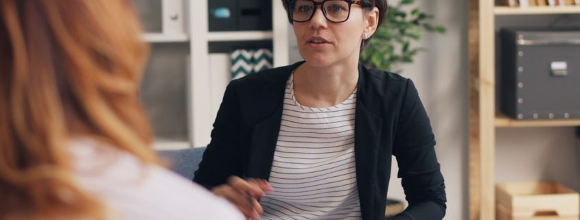 Two women in a couch-based therapy session — trauma-informed residential addiction treatment